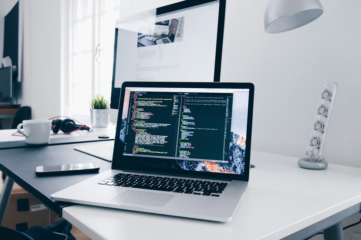 http://Laptop%20and%20external%20monitor%20showing%20web%20application%20code